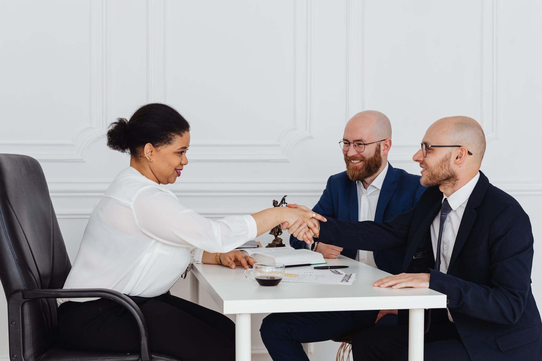 businessmen in a meeting with a businesswoman
